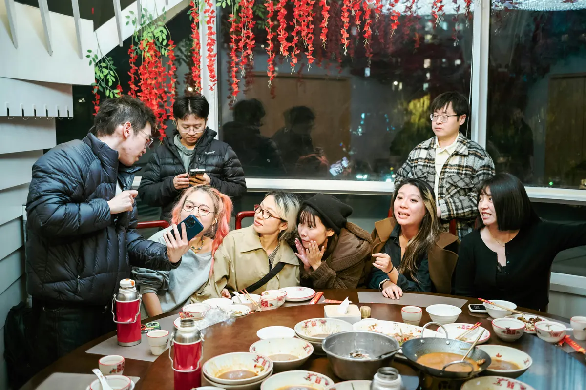 Friends gathered around a restaurant table at the end of a shared dinner